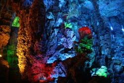 sixpenceee:    The Reed Flute Cave    The Reed Flute cave is a popular tourist attraction in Guilin, China. Inside this water-eroded cave is a spectacular world of various stalactites, stone pillars and rock formations created by carbonate deposition.