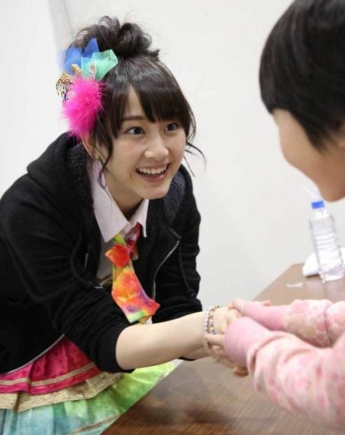 that creepy look on her face while handshaking with a kid XD