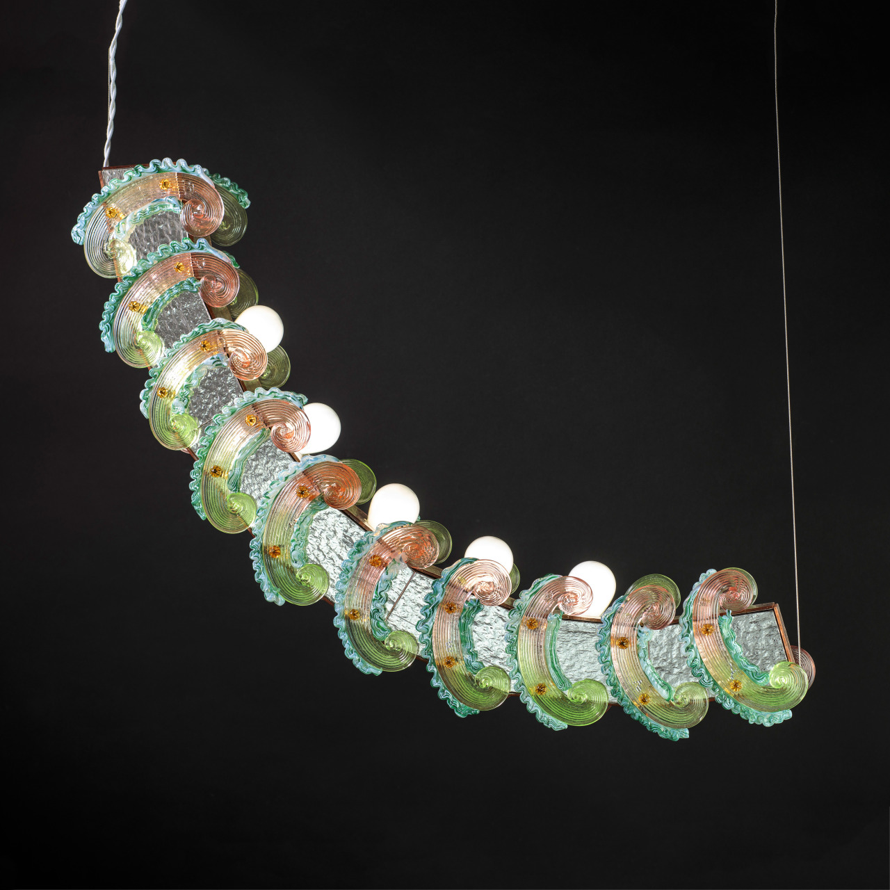 ToppingsA collection of four lamps made of tinted venetian mirrored glass combined with traditional decorative glass curls and pins, which are used as if they were a layer of cream, colored buttercream or thick frosting spread on a base as a garnish....