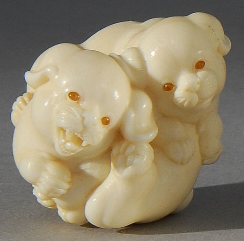 Ivory netsuke, Contemporary By Kangyoku. Depicting two playful puppies with double inlaid eyes. Sign