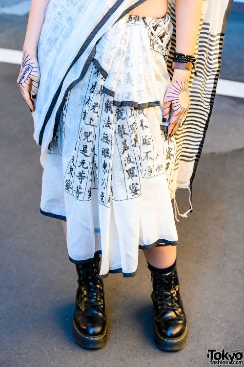 Japanese PHD neuroscience student Yoritam (she/they) on the street in Harajuku wearing a kanji print