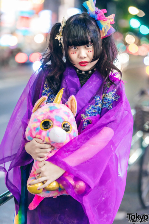 Japanese art student Chami on the street in Harajuku at night wearing a kimono coat from the iconic 