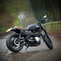 visuallyillusive:  Remember the race-winning Triumph Trophy bikes from the 50s and 60s? Here’s a pumped-up modern Bonnie given the retro enduro treatment, built by England’s Spirit Of The 70s. Check that exhaust system: it’s got a F1-style Zircotec