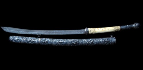 art-of-swords:Dha SwordDated: 19th centuryCulture: BurmeseMedium: steel, ivory, silverThe sword feat