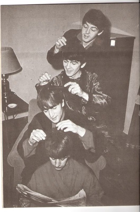 gorgonetta:[B/w photo of The Beatles engaging in social grooming while Ringo reads]