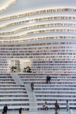 stylish-homes:  Tianjin Binhai Library, located outside Beijing, has massive bookshelves that contour the library’s walls, rolling across the ceiling like waves. via reddit Keep reading