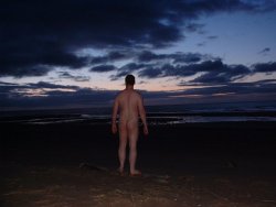 Naked on the beach,  The first light of the