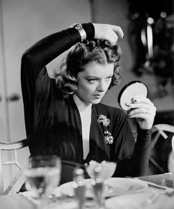 margotfonteyns:  Myrna Loy arranging her coiffure, 1941 