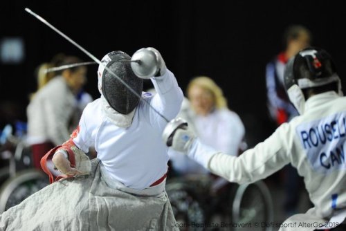 [ID: a wheelchair epee fencer parrying his opponent’s attack.]Ryan Rousell (right) at Montreal