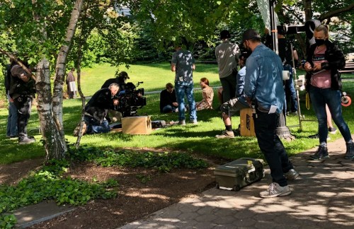 The big question: Who is the man sitting on the grass with Lotte?(photo by Roosevelt Island Daily Ne