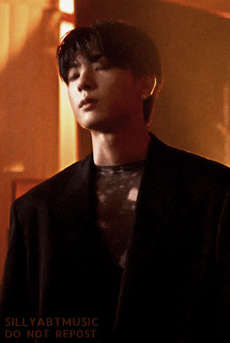 Kanghyun turning to look at the camera, the light glaring