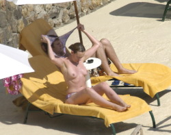 toplessbeachcelebs:  Toni Collette (Actress) sunbathing topless in Italy (December 2005)