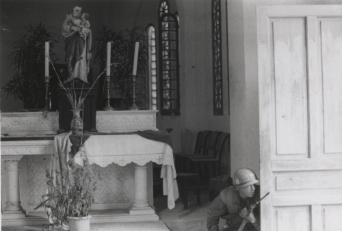demons: A Marine taking cover behind a church door during the Battle of Hue/February 1968