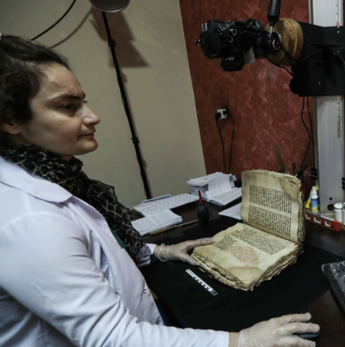 A conservator creates scans of damaged ancient Christian manuscripts rescued from Mosul in the after