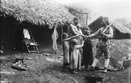 greatwar-1914:A soldier says goodbye to his family as he departs for the war.  German East Africa, c