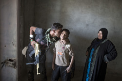 yahoonewsphotos:  Photos of the day - October 29, 2016 A member of Iraqi armed forces kisses a local boy after Iraqi forces entered the town of Shura, south of Mosul, Iraq; A woman passes by a giant pumpkin created by Master Carver Hugh McMahon with the