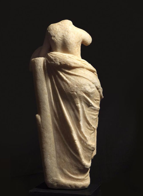 mini-girlz:  A Greek marble figure of Aphrodite  Hellenistic Period, circa 2nd Century B.C. The goddess depicted standing with her weight on her right leg, her left knee relaxed, with sinuous curved torso, the drapery falling in folds around her lower