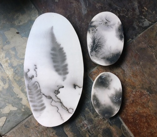 experimental raku plaques with feathers, dried flowers, fern fronds and horse and human hair