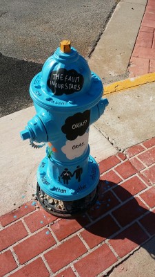 fishingboatproceeds:  writingofcourse:  Our town paints fire hydrants. 2014’s theme is books! Here is their ode to John Green’s The Fault in Our Stars. The artist for this hydrant is Paul Siegfried.  It’s located on the corner of Jefferson and