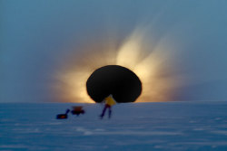 scientistmary:  This is what a total Solar eclipse looks in Antarctica, near the bottom of the world. It occurs when the dark silhouette of the Moon completely obscures the intensely bright light of the Sun. The sudden darkness lets the magnificent corona