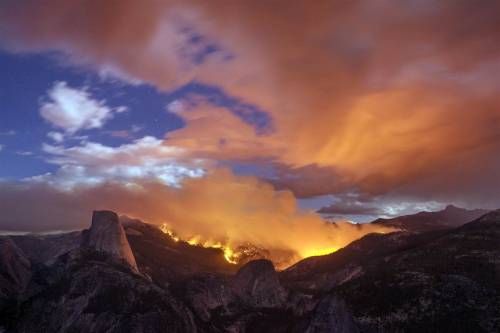 nyctaeus:A wildfire burns next to Half Dome in Yosemite National Park, Calif. on Sept. 7, 2014. Abou