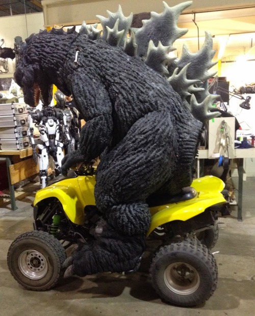 Actor Douglas Tait in a full Godzilla suit goofing around on a quad. #MonsterSuitMonday Notice that 