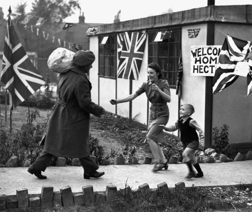 Daddy’s home! October 1945, Tulse Hill, London- Gunner Hector Murdoch greeted by his beloved wife Ro
