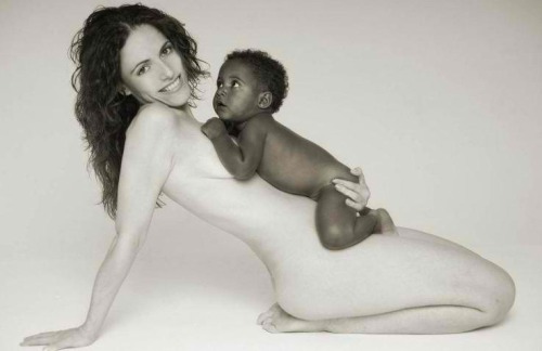 This white lady is overfilled with joy because she has a brought a Black baby into this world.