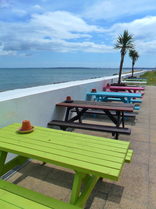 vwcampervan-aldridge:Bright coloured benches, Spinnaker Bar, Calshot Beach, New Forest, Hampshire, E