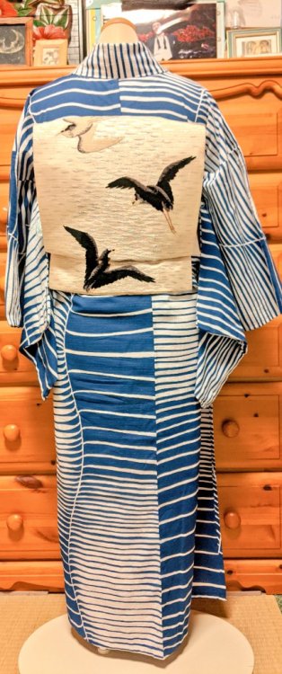 Nautical inspired outfit, pairing a modern graphic yukata with a shimmering antique obi depiciting s