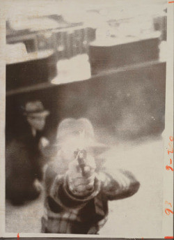 sixpenceee:  A photograph of a bank robber trying to shoot out security camera, 1975. (Source) 