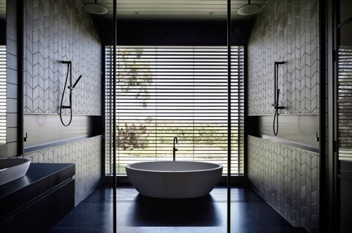 {Australian firm Canny Architecture went for a modern barn kind of aesthetic in this home, with dark