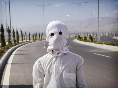 et-alia:A gardener shrouded against the sun on a 40C day in Ashgabat. Despite their country’s 