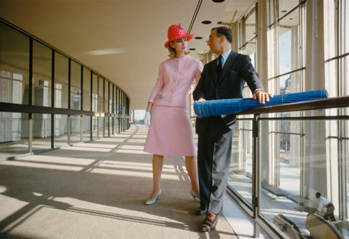 Model wearing a pink suit photographed with an architect at Lincoln Center in 1962.