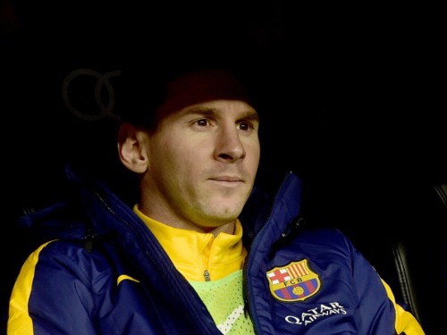 Lionel Messi sits on the bench during Real Madrid CF vs FC Barcelona at the Santiago Bernabeu stadiu