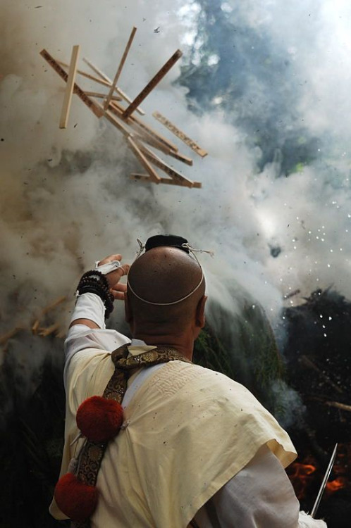 Yamabushi (Japanese mountain ascetic hermits) performing a ritual of making offerings into consecrat