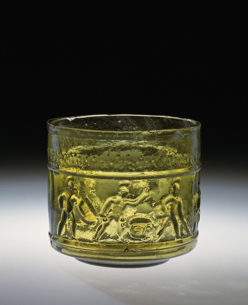 apuleiaprimilla:Transparent yellowish-green glass cup. On the body, two friezes, each with horizonta