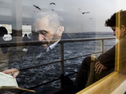 natgeotravel: Reflections: A young boy casts a striking comparison to an aging man lost in a book on a ferry in Istanbul.  Photograph by Merve Ates, National Geographic Your Shot 