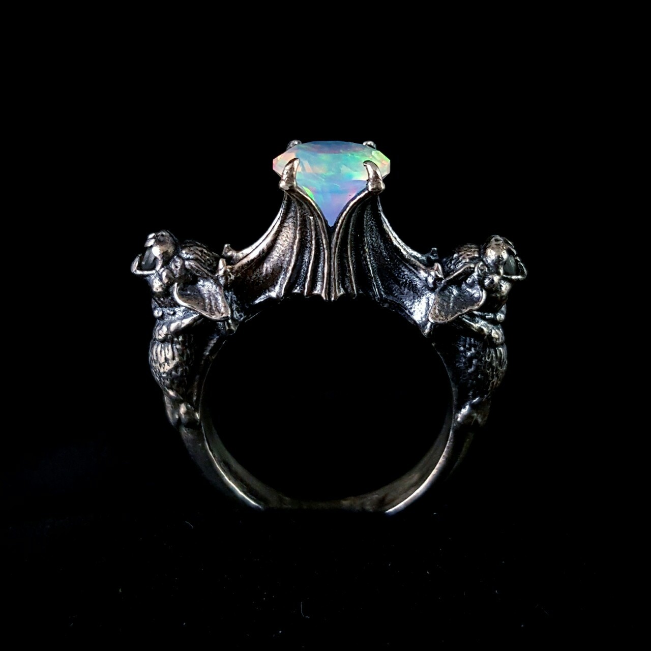 omniastudios:  Nocturne bat ring with a fiery Gilson opal.  www.omniastudios.com