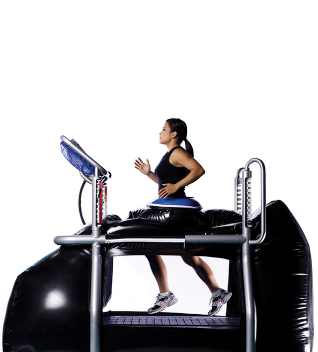 A woman in exercise clothes runs in the pressurized, enclosed anti-gravity G-Trainer treadmill.

Credit: Alter-G Inc.
