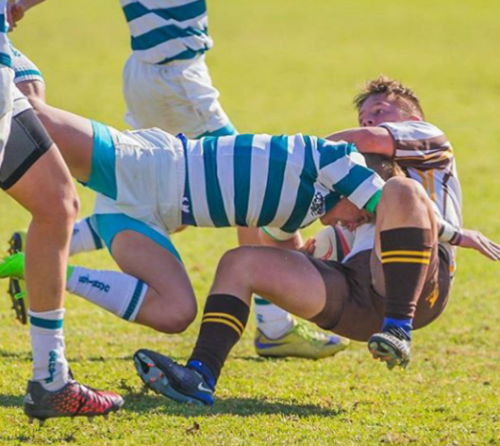 School boys rugby tackle. Tight shorts and feet covered in socks and rugby sports boots. Check those