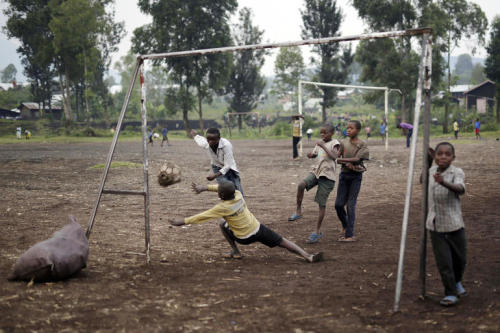 Children play football on a dirt field in Goma, Democratic Republic of Congo on June 18, 2016. (Jero