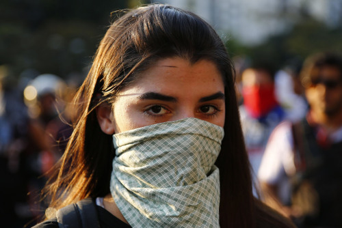 andreinandrea:  A Venezuelan protester poses for a portrait at Altamira square in Caracas. Estos son los estudiantes, que sin armas, protestan en Altamira, municipio Chacao, contra el gobierno de Nicolás Maduro, Jóvenes que luchan y arriesgan sus vidas