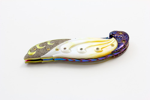 roachpatrol:  whiskey-wolf:  Ū,500.00 Titanium and Gold Lip Pearl Linerlock This knife is from Suchat’s New Diamond Edition. This liner locking folder features a carved Robert Calcinore Mosaic Damascus blade. The handle has carved titanium bolsters,