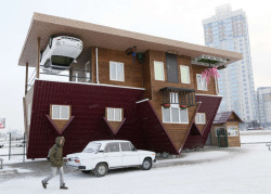 the-gasoline-station:  Upside-down A man passes a house built upside-down in Russia’s Siberian city of Krasnoyarsk. The house was constructed as an attraction for local residents and tourists. Picture: Ilya Naymushin/Reuters