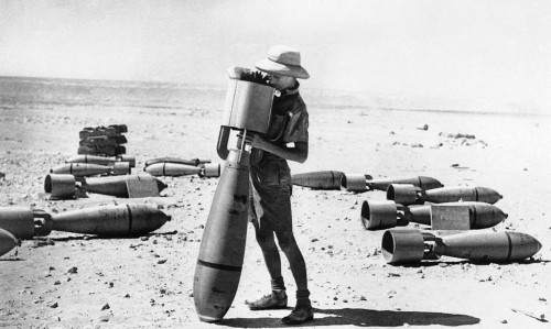 An armourer of the RAF Middle Eastern Command prepares a bomb for amission against the Italian force