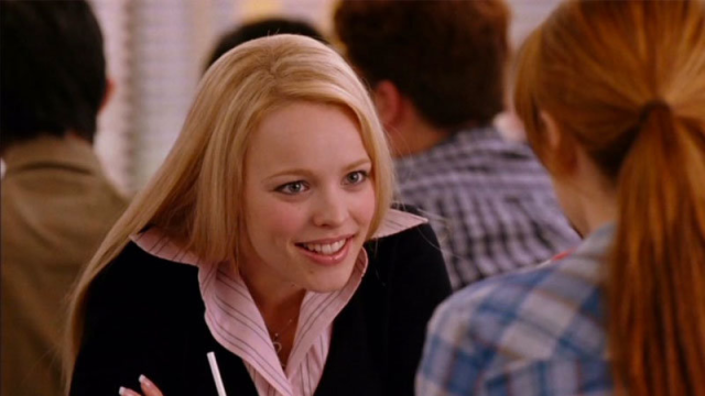 A screenshot of Regina George from Mean Girls leaning forward intently.