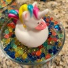 Unicorn duck floating on a small pond of adult photos