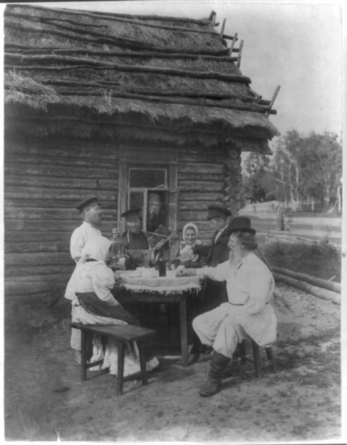 A group of Russian peasants gathered around a man with a balalaika, c. 1875 (via Library of Congress