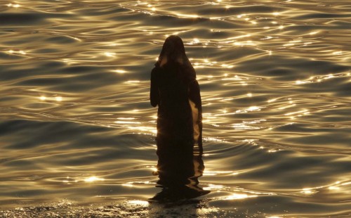 o-g-steve:awkwardsituationist:indian hindu devotees offer prayers to the sun in the arabian sea duri